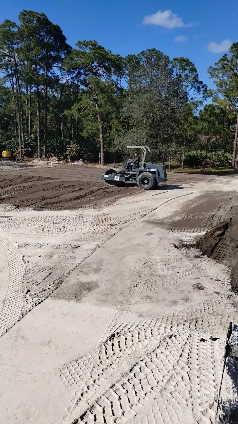 Building pad compaction with a roller