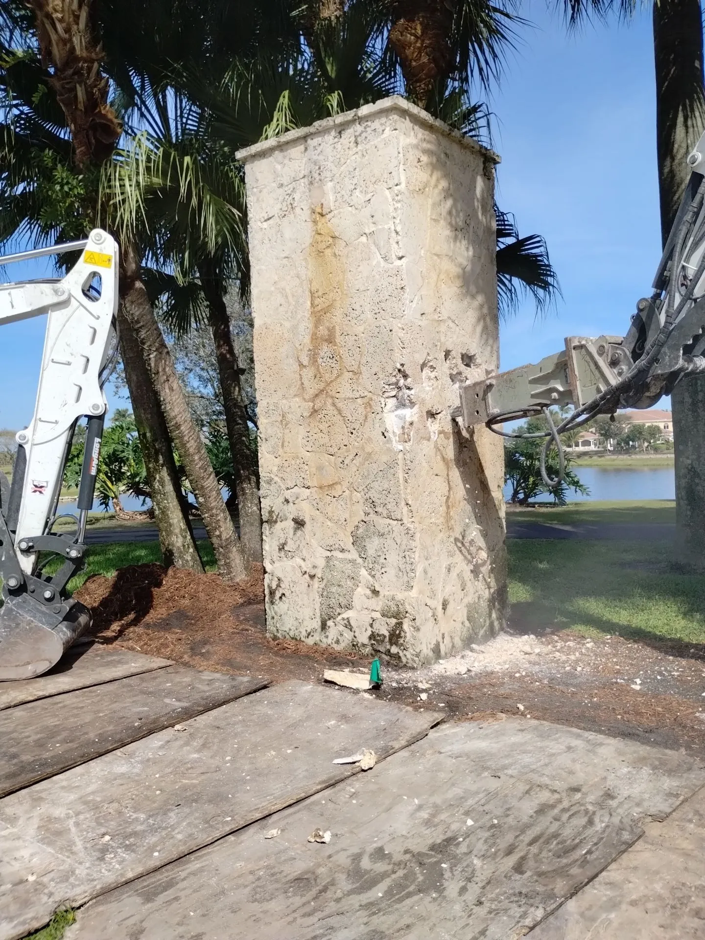 Demolition of decorative column with hammer attachment