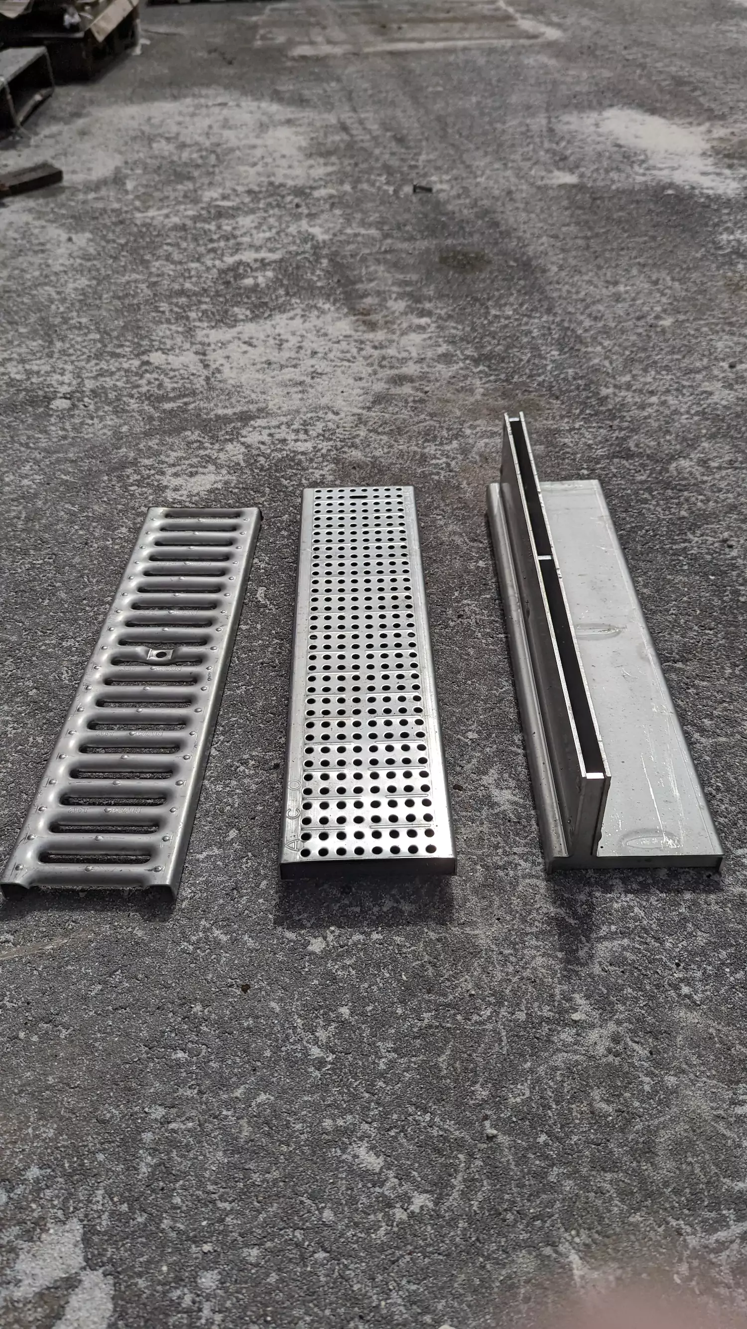 regular 6 inch stainless grate, a heel safe grate, and a slot drain
